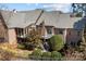 Aerial rear view of a brick home showcasing a deck, screened porch and landscaped backyard at 8034 Bay Pointe Dr, Denver, NC 28037
