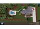 Aerial view of a charming home with a lush yard, pool, and two-car garage at 8034 Bay Pointe Dr, Denver, NC 28037