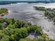 An aerial view shows the surrounding lake and lush green trees, with docks along the waterfront at 8034 Bay Pointe Dr, Denver, NC 28037