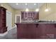 Finished bar with wooden cabinets and a granite countertop, perfect for entertaining at 8034 Bay Pointe Dr, Denver, NC 28037