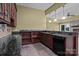 Wet bar area featuring dark wooden cabinetry, granite countertops, and a stone backsplash at 8034 Bay Pointe Dr, Denver, NC 28037