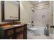 Full bathroom with a wooden vanity, a tiled shower over a tub, and updated fixtures at 8034 Bay Pointe Dr, Denver, NC 28037
