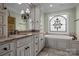 Elegant bathroom featuring double vanity, granite countertops, ornate mirror, and a beautiful stained glass window above tub at 8034 Bay Pointe Dr, Denver, NC 28037
