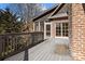 Spacious deck with railing, offering access to a screened porch and backyard at 8034 Bay Pointe Dr, Denver, NC 28037