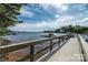 Lake view from a dock featuring wood planks and railing along the edge with boat docks on the water at 8034 Bay Pointe Dr, Denver, NC 28037