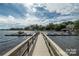 View from the end of a long wooden dock on the lake with docks and boats on either side at 8034 Bay Pointe Dr, Denver, NC 28037