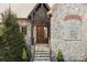 Close-up of the stone front entrance and heavy wood doors at 8034 Bay Pointe Dr, Denver, NC 28037