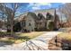 Beautiful home featuring a stone and brick exterior, manicured landscaping, and a driveway at 8034 Bay Pointe Dr, Denver, NC 28037