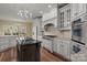 Gourmet kitchen with a large island, stainless steel appliances, and custom cabinets at 8034 Bay Pointe Dr, Denver, NC 28037