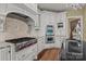 This kitchen features a large island, professional grade cooktop, and custom cabinets at 8034 Bay Pointe Dr, Denver, NC 28037