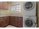Practical laundry room with a stacked washer and dryer and ample cabinet space at 8034 Bay Pointe Dr, Denver, NC 28037