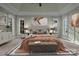 A spacious main bedroom with a tray ceiling, a gray upholstered bed frame, and a beige-themed color palette at 8034 Bay Pointe Dr, Denver, NC 28037