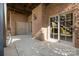 Covered brick patio featuring a door and sliding glass doors to the interior at 8034 Bay Pointe Dr, Denver, NC 28037