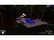 Evening view of a luxurious pool area, featuring a covered bar and grill and plenty of comfortable seating at 8034 Bay Pointe Dr, Denver, NC 28037