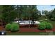 Relaxing pool area nestled in a wooded area with an umbrella and beautiful landscaping at 8034 Bay Pointe Dr, Denver, NC 28037