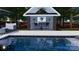 Covered bar and grill area including a Golf Channel television, bar-height seating, and comfortable seating by the pool at 8034 Bay Pointe Dr, Denver, NC 28037