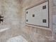 Stone tiled shower featuring a mosaic tile floor and a decorative tiled insert at 8034 Bay Pointe Dr, Denver, NC 28037