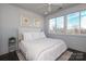 Bright bedroom featuring a large window and a comfortable bed with white linens and decorative artwork at 932 Cityscape Dr, Charlotte, NC 28205