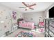 Bright bedroom with ceiling fan, gray walls, and colorful decor at 932 Tiger Ln, Charlotte, NC 28262