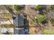 Aerial view of a property featuring a roof, a driveway, landscaping, and mature trees at 1016 Helms Rd, Charlotte, NC 28214
