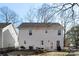 Back of home with a patio, grill, dining set, and a spacious fenced yard at 1016 Helms Rd, Charlotte, NC 28214