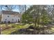 Lush backyard with a patio, landscaping, mature trees, and a privacy fence at 1016 Helms Rd, Charlotte, NC 28214