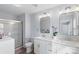 Modern bathroom featuring double sinks, white cabinetry, and a glass-enclosed shower at 1016 Helms Rd, Charlotte, NC 28214