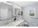 Elegant bathroom featuring double sinks, quartz counters, and contemporary fixtures at 1016 Helms Rd, Charlotte, NC 28214