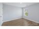 A simplistic bedroom with a window to let in natural light at 1016 Helms Rd, Charlotte, NC 28214