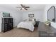 Well-lit bedroom featuring a comfortable bed, dresser, and stylish decor at 1016 Helms Rd, Charlotte, NC 28214