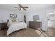 Bright bedroom with ceiling fan, walk-in closet, and ensuite bathroom with double sinks at 1016 Helms Rd, Charlotte, NC 28214