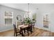Well-lit dining area featuring a wood table set, complemented by natural light from nearby windows at 1016 Helms Rd, Charlotte, NC 28214