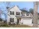 Beautiful two-story home with white siding, black shutters, and a well-maintained lawn with garden beds at 1016 Helms Rd, Charlotte, NC 28214