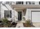 Inviting front entrance with a decorative wreath, manicured landscaping, and a well-lit porch area at 1016 Helms Rd, Charlotte, NC 28214