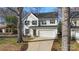 Charming two-story home with a well-maintained lawn, driveway, and attached garage at 1016 Helms Rd, Charlotte, NC 28214