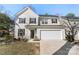 Well-maintained two-story home with a manicured front lawn, a driveway, and an attached garage at 1016 Helms Rd, Charlotte, NC 28214
