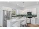 Sleek kitchen with stainless steel appliances, white cabinets, and a stylish island with seating at 1016 Helms Rd, Charlotte, NC 28214