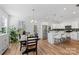 Modern kitchen with stainless steel appliances, a spacious island, and an adjacent dining area with backyard access at 1016 Helms Rd, Charlotte, NC 28214