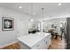 Open kitchen with a large island, seamlessly flowing into the dining and living areas at 1016 Helms Rd, Charlotte, NC 28214