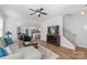 Open-concept living room with a ceiling fan, wood flooring, and seamless transition to the kitchen and dining area at 1016 Helms Rd, Charlotte, NC 28214