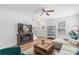 Cozy living space with a decorative fireplace, adjacent to the stairway, and a large sectional sofa at 1016 Helms Rd, Charlotte, NC 28214