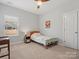 Well-lit bedroom with a ceiling fan, carpeted floors, and a window with blinds at 1016 Hickory Pine Rd, Waxhaw, NC 28173