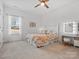 Bright bedroom with ceiling fan, full bed, and vanity with lighted mirror at 1016 Hickory Pine Rd, Waxhaw, NC 28173