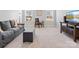 Cozy bonus room featuring a sofa, desk, and natural light from the windows at 1016 Hickory Pine Rd, Waxhaw, NC 28173