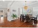 Elegant dining room with hardwood floors, a stylish chandelier, and large windows for natural light at 1016 Hickory Pine Rd, Waxhaw, NC 28173