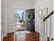 Bright foyer featuring hardwood floors, a decorative wreath on the open door, and a view of the exterior at 1016 Hickory Pine Rd, Waxhaw, NC 28173