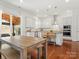 Bright, white kitchen boasts stainless appliances, subway tile backsplash and center island with seating at 1016 Hickory Pine Rd, Waxhaw, NC 28173