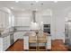 Bright kitchen features stainless appliances, white cabinets, granite counters, and central island with seating at 1016 Hickory Pine Rd, Waxhaw, NC 28173