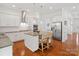 This kitchen features white cabinets, granite countertops, a stainless fridge, and a center island at 1016 Hickory Pine Rd, Waxhaw, NC 28173