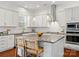 Modern kitchen featuring white cabinets, granite countertops, stainless steel appliances, and a center island with seating at 1016 Hickory Pine Rd, Waxhaw, NC 28173